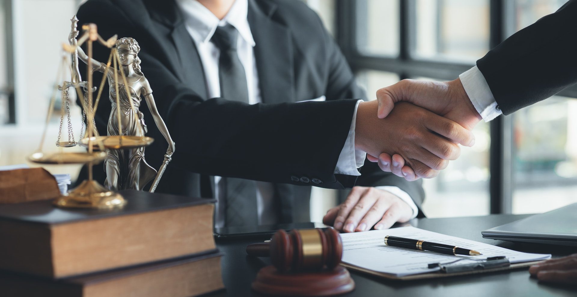 lawyer-and-client-shake-hands–e1675415255393.jpg